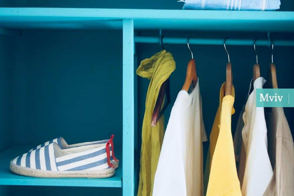 blue shelf with pair of slip-ons and five clothes